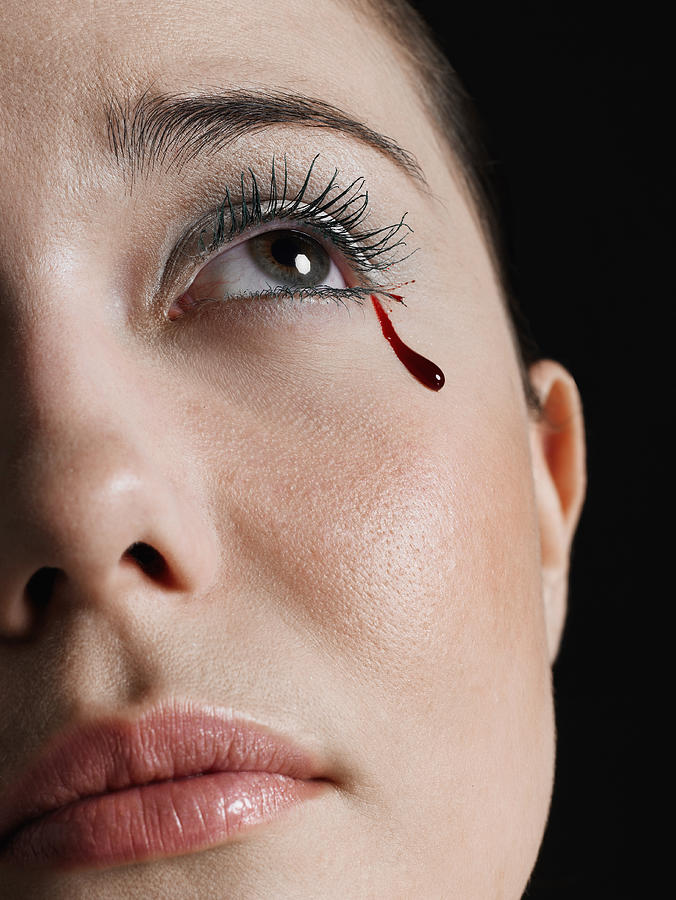 Young woman crying tear of blood, close-up of face #1 Photograph by Christopher Robbins