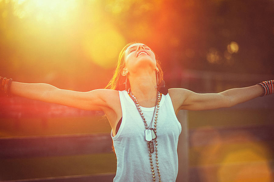 Young woman outstretched arms enjoys the freedom and fresh air #1 Photograph by Gruizza