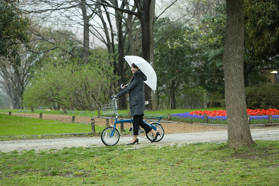 Young Woman Pushing the Bicycle in the Park, Side View  #1 Photograph by Daj
