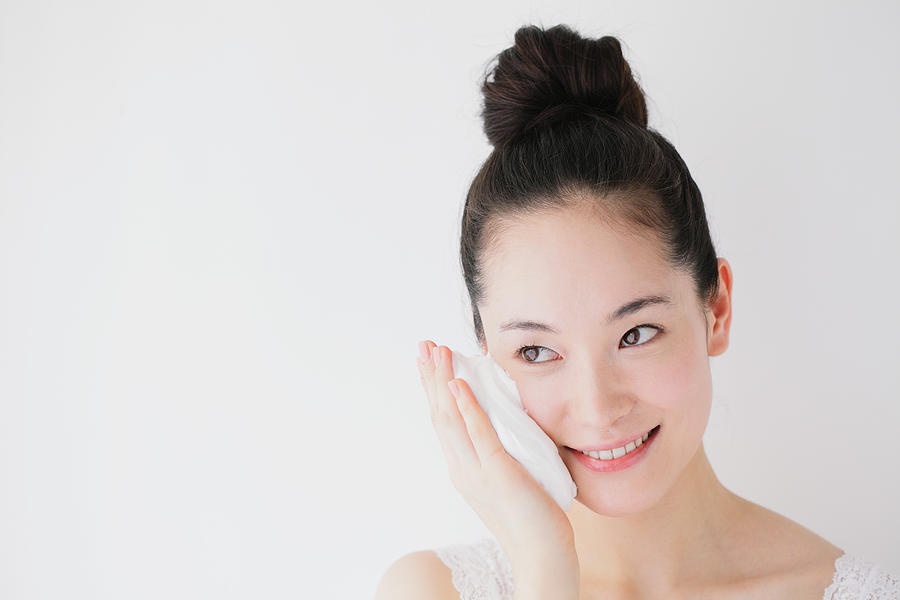 Young woman putting face-wash foam #1 Photograph by Yosuke Tanaka/Aflo