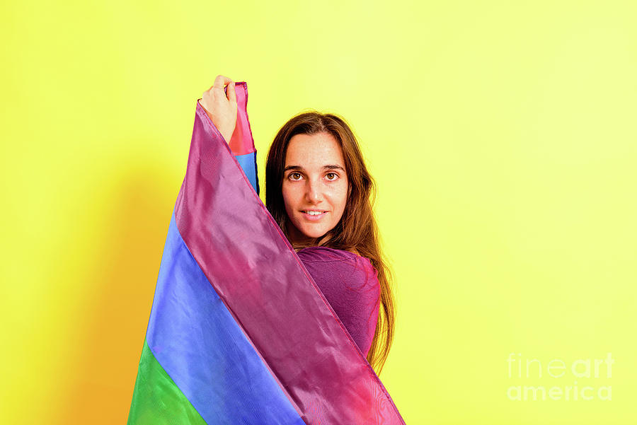 Young woman rolled up in a gay pride flag. Photograph by Joaquin ...