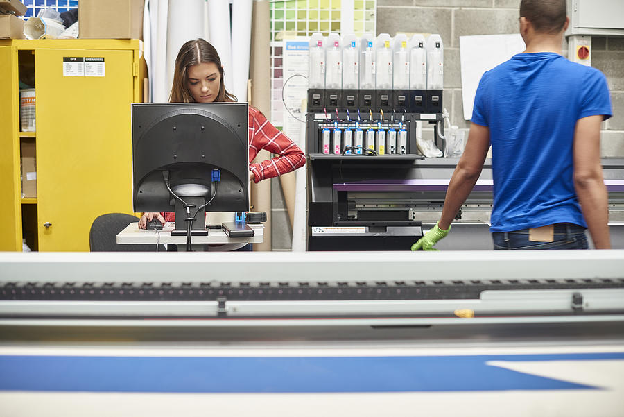 Young Woman Working At A Digital Printing Company #1 Photograph by Sturti