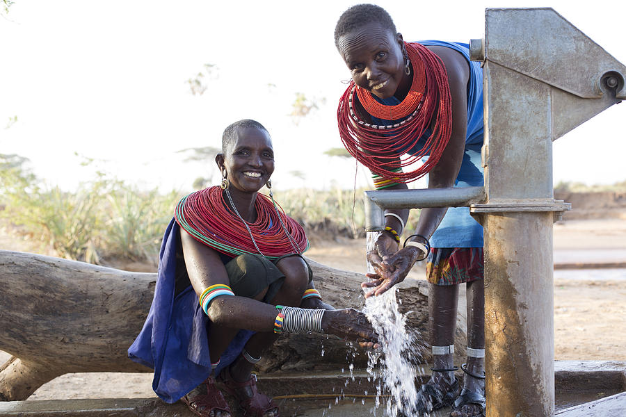 Women collecting clean water from borehole in desert. Samburu. Kenya. #10 Photograph by Hugh Sitton