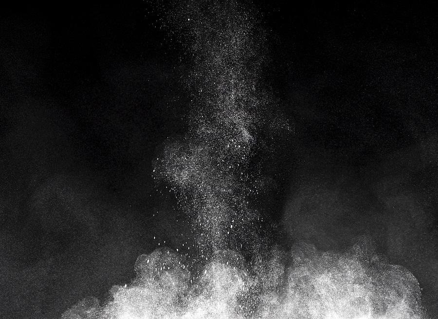 Blackground of particles of white powder in ascending movement floating in the air produced by an impact #11 Photograph by Jose A. Bernat Bacete