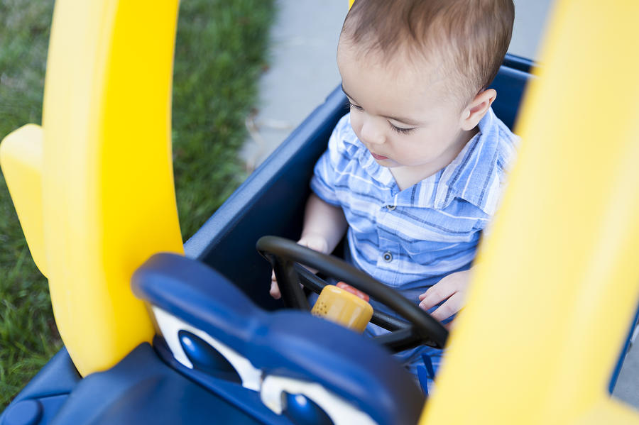 12 Month Old Baby Plays in Plastic Toy Car and Pretends to Drive Photograph by Jill Lehmann Photography