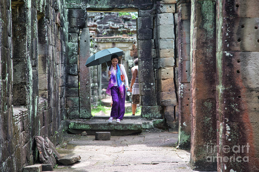 Buddha Photograph - 12th Centruy Cambodia Ruins Asian Woman Umbrella Passage  by Chuck Kuhn