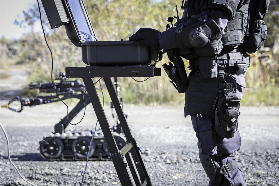 Police Swat Officer Using a Mechanical Arm Bomb Disposal Robot Unit #13 Photograph by Onfokus