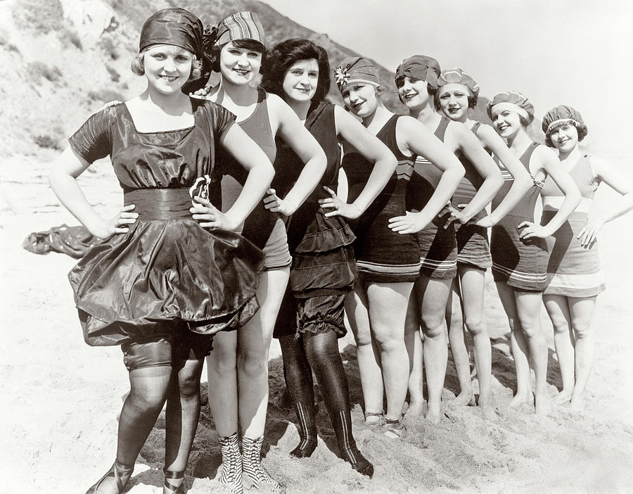 1920s Group Of Smiling Women Wearing One Piece Bathing Suits And Caps Posing Lined Up On Beach Photograph by Panoramic Images