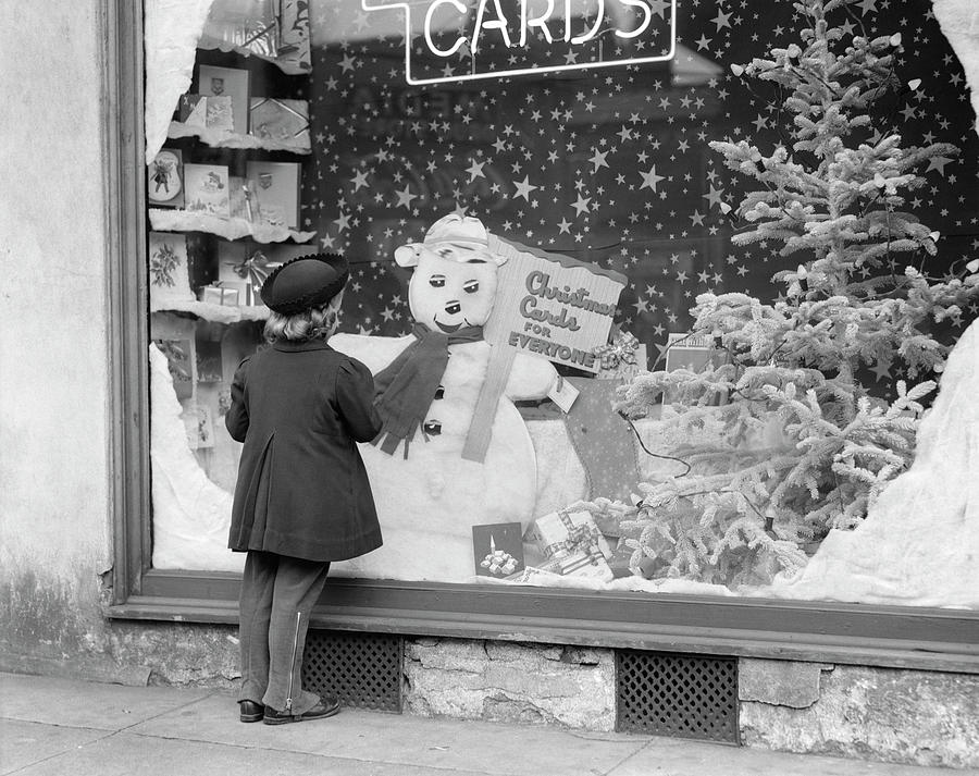 1930s 1940s Little Girl Look Into Card Shop Window With Christmas Decorations And Snowman Display Photograph by Panoramic Images