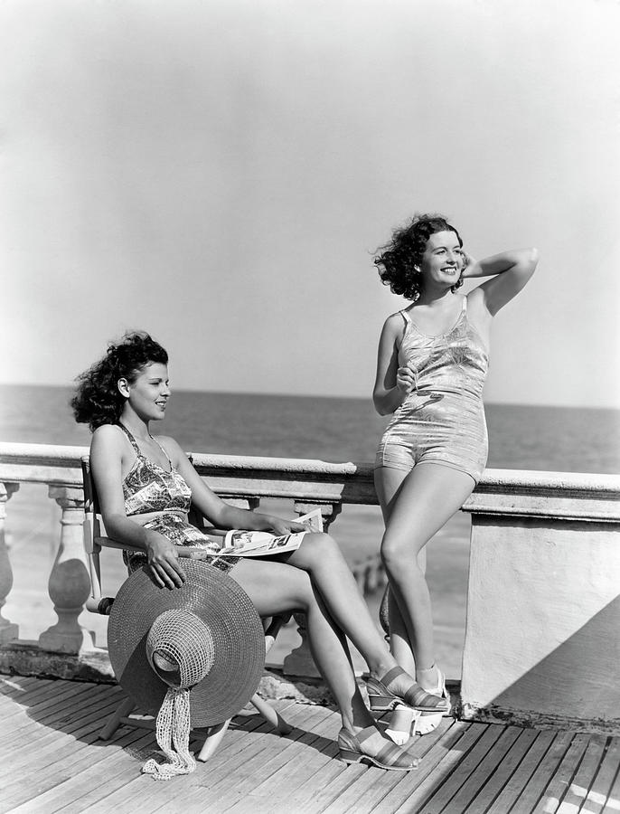 1930s 1940s two women sitting on hotel deck beach side in one piece bathing  suit fashion Florida USA Photograph by Panoramic Images - Fine Art America