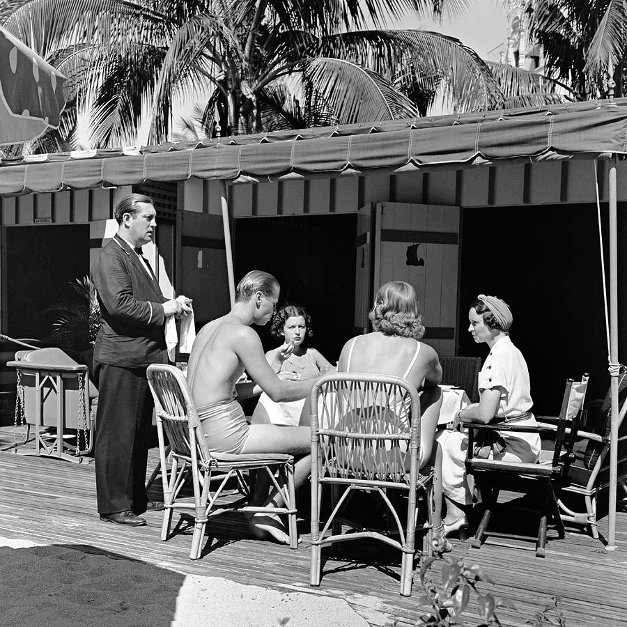 1930s three women one man dining by beach waiter taking order nautilus hotel cabana club Miami Beach Photograph by Panoramic Images 1930s three women one man dining by beach waiter taking order nautilus hotel cabana club Miami Beach Photograph by Panoramic Images