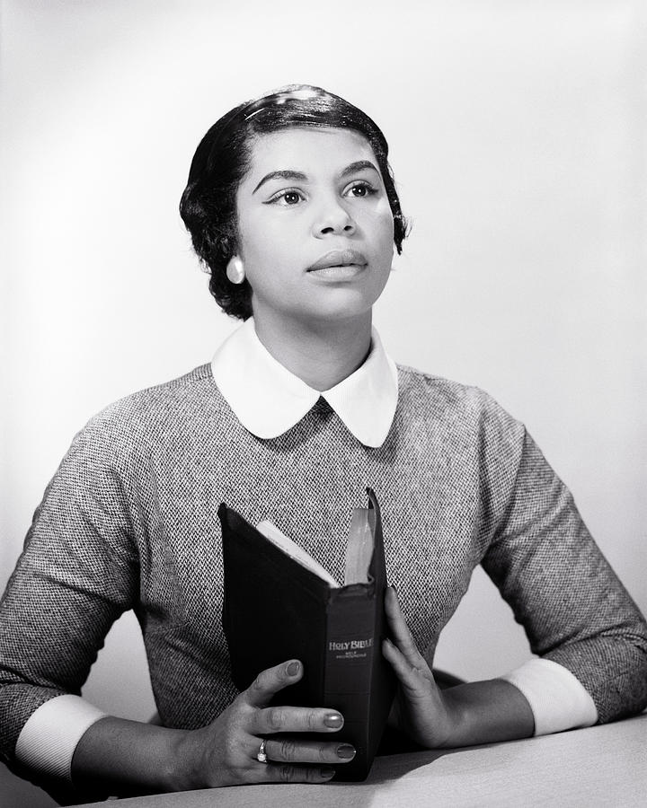 1950s 1960s African American woman holding bible looking up praying Photograph by Panoramic Images