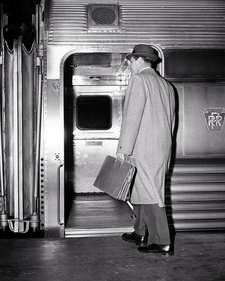 1950s Back View Of A Man Businessman Carrying Leather Briefcase Wearing Top Coat And Hat Commuter Photograph by Panoramic Images