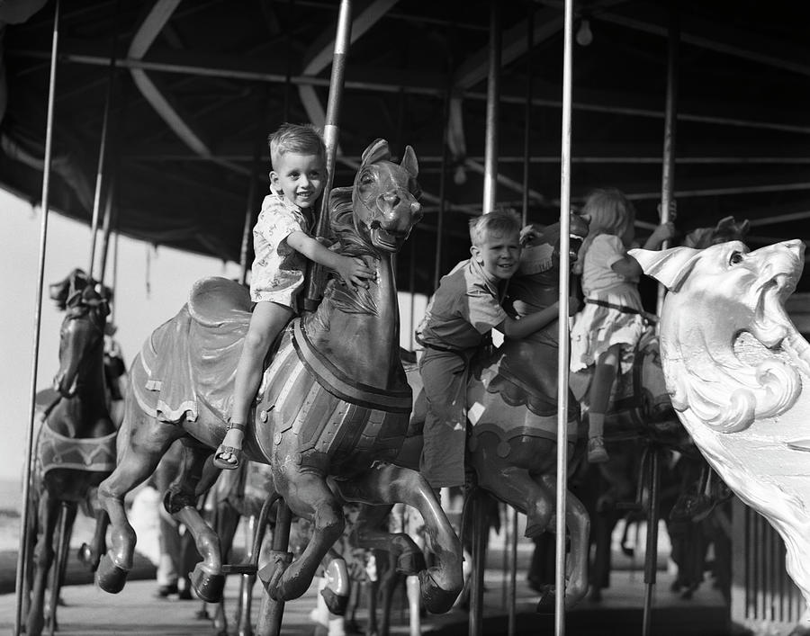 1950s Children On Carousel 2 Smiling Boys Leaning To Side Off Of Horses ...