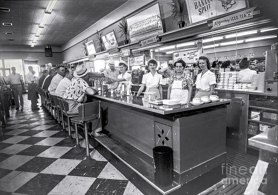 Black And White Photograph - 1950s Crowded Diner In The Midwest by Ok More Photos