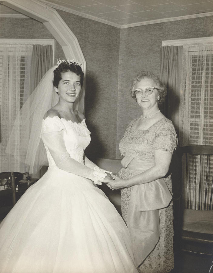 1950s Portrait of a Woman in a Wedding Dress Holding Hands With Her Mother Photograph by Digital Vision.