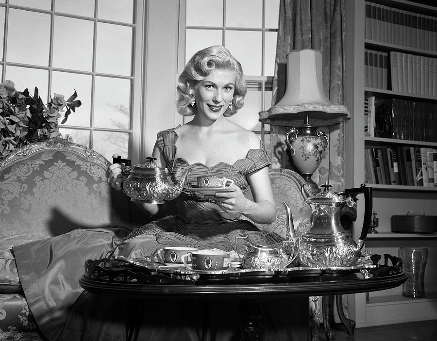 1950s Smiling Blond Woman Elegant Dress And Home Furnishings Pouring ...