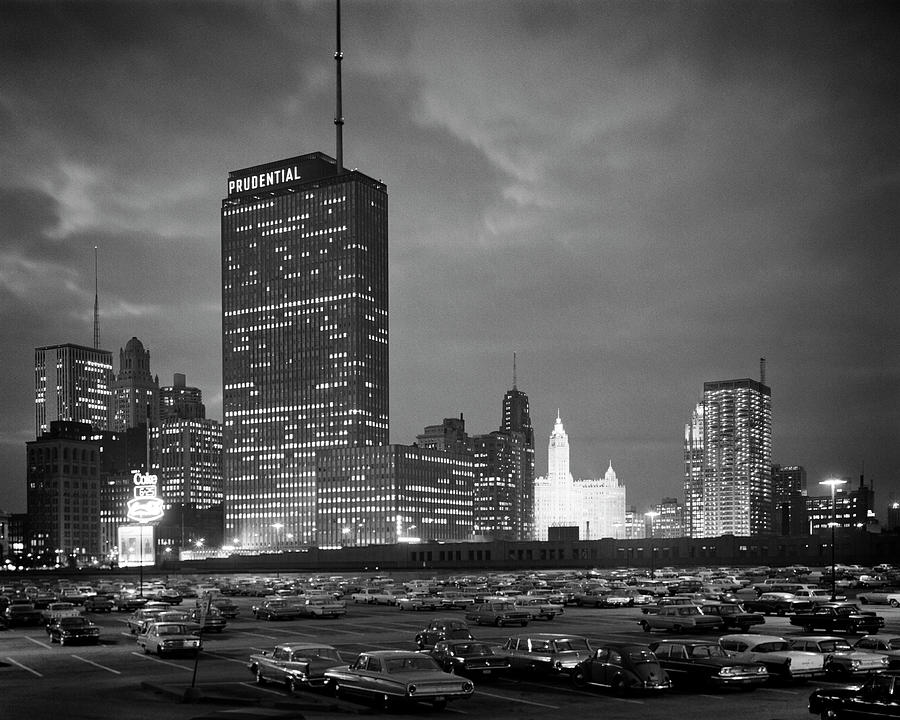 1960s night skyline of Prudential Building and brightly lit Wrigley Building from Monroe Drive Photograph by Panoramic Images