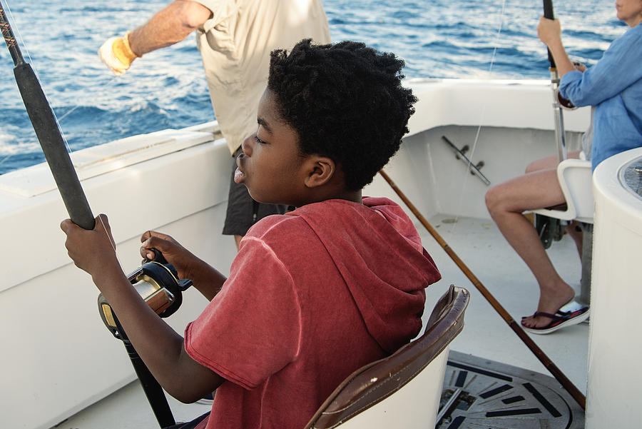 African-american boy on a sea fishing trip. #2 Photograph by Martinedoucet