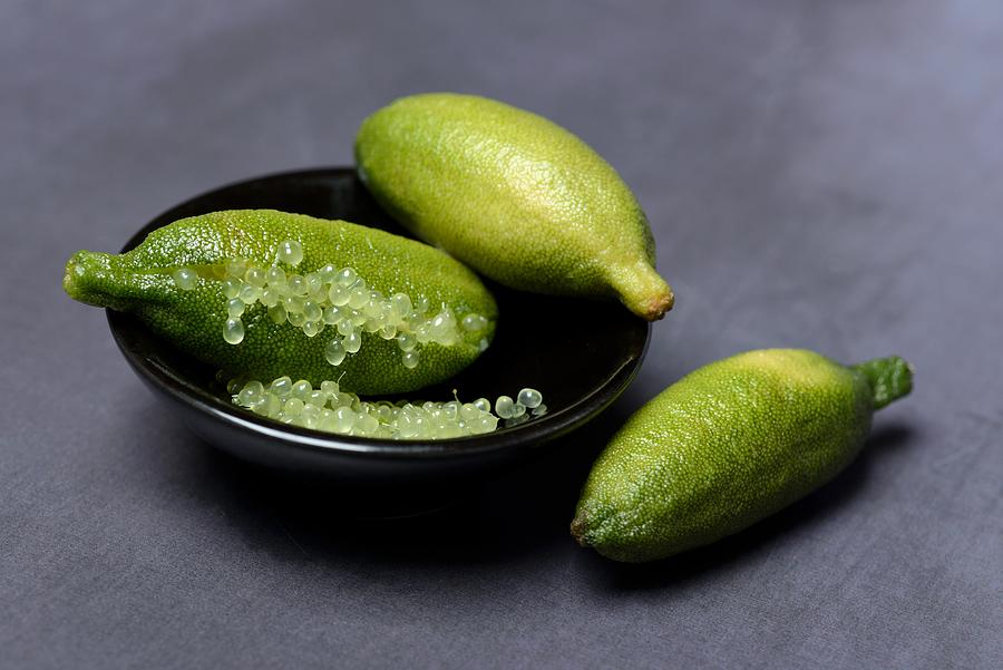 Australian finger lime (Microcitrus australasica) in bowl, finger lime, lime caviar, Germany #2 Photograph by imageBROKER/Juergen Pfeiffer