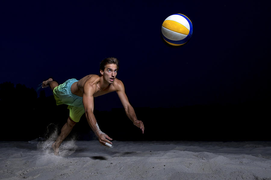 Beach volleyball player digging the ball #2 Photograph by Tomas Rodriguez