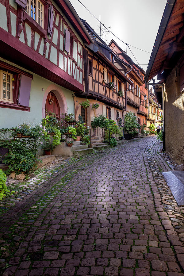 Beautiful view of charming street scene with colorful houses in the historic town of Eguisheim on an idyllic sunny day with blue sky and clouds in summer #2 Photograph by Karlaage Isaksen