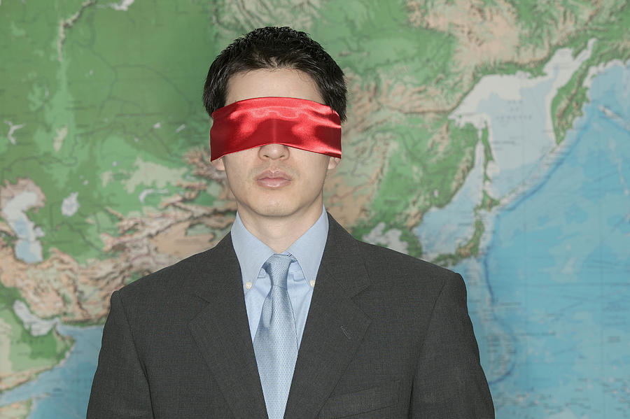 Blindfolded businessman in front of world map #2 Photograph by Comstock Images