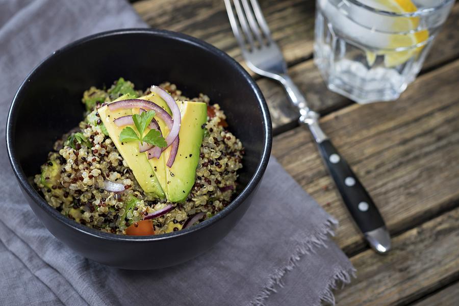 Bowl of Quinoa tricolore with avocado, red onion, tomatoes and flat leaf parsley #2 Photograph by Westend61