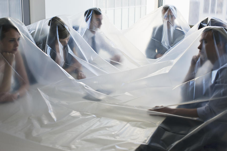 Business people covered in plastic in conference room #2 Photograph by Tom Merton