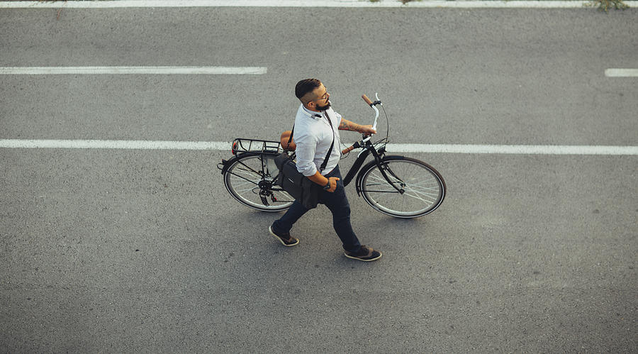 Businessman Pushing Bicycle and going home late. #2 Photograph by Vgajic