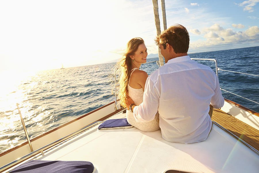 Caucasian couple sitting on yacht deck #2 Photograph by Colin Anderson Productions pty ltd