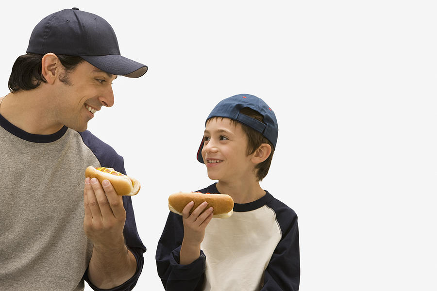 Caucasian father and son eating hot dogs #2 Photograph by Jose Luis Pelaez Inc