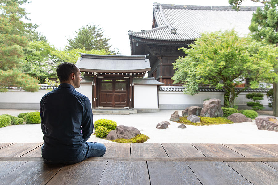 Caucasian man looking at temple garden #2 Photograph by Kumikomini