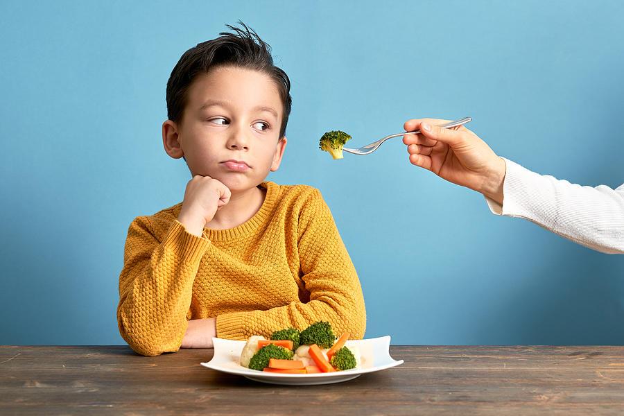 Child is very unhappy with having to eat vegetables. #2 Photograph by Pinstock