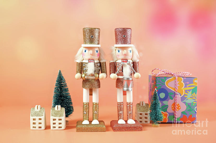 Christmas nutcracker ornaments and gifts against a modern coral background. #2 Photograph by Milleflore Images