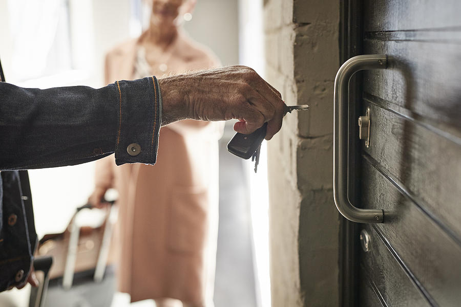 Close-up of mature couple opening door to holiday rental apartment with key #2 Photograph by Klaus Vedfelt
