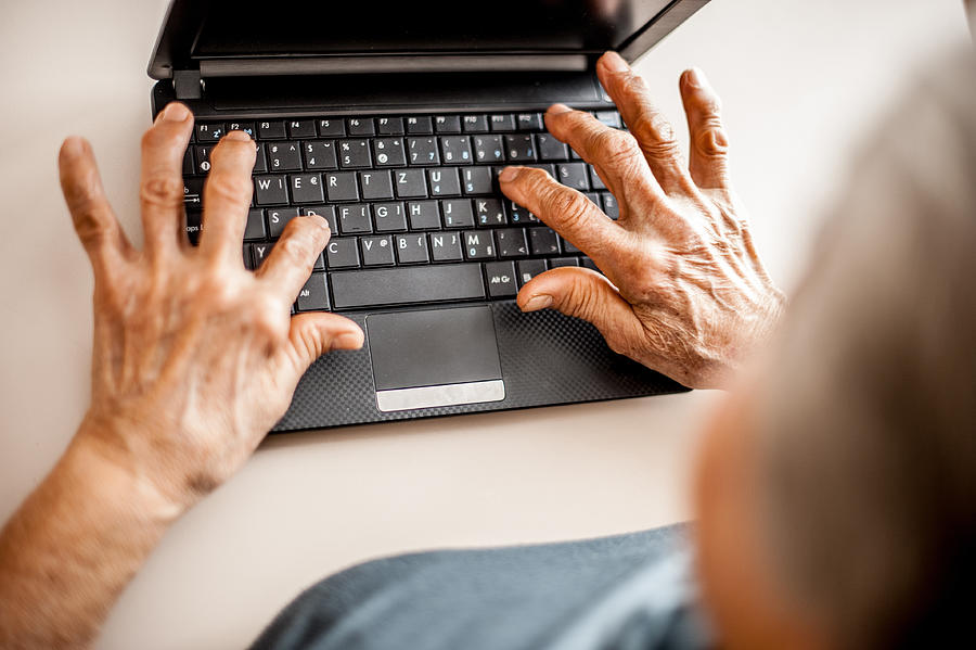 Close Up Senior Woman Old Hands Using Laptop #2 Photograph by CasarsaGuru
