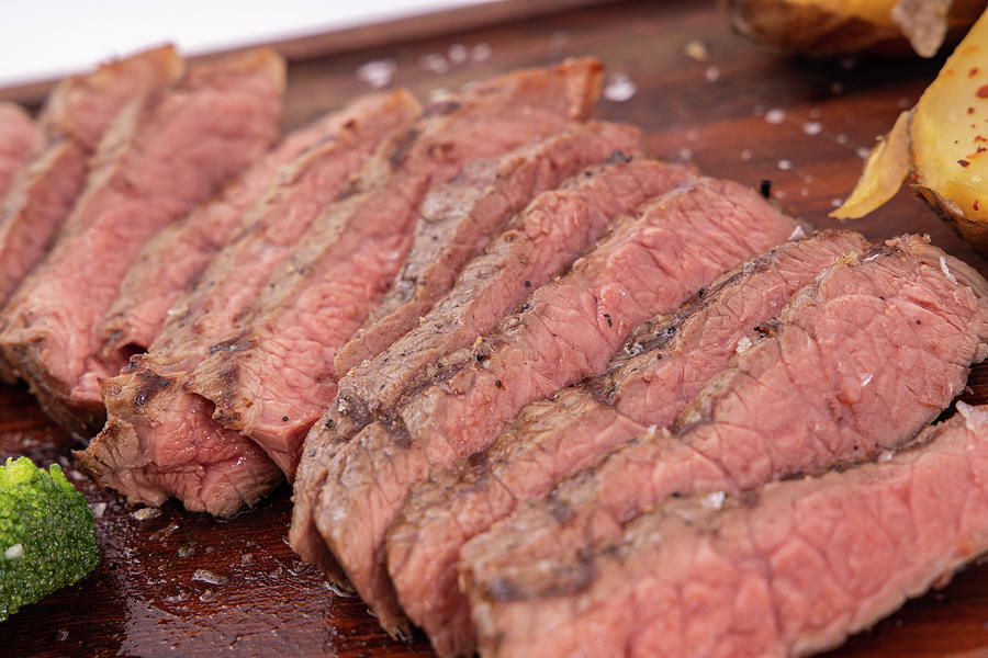 Close Up Sliced Steak. Delicious Steak On Wooden Board. Photograph