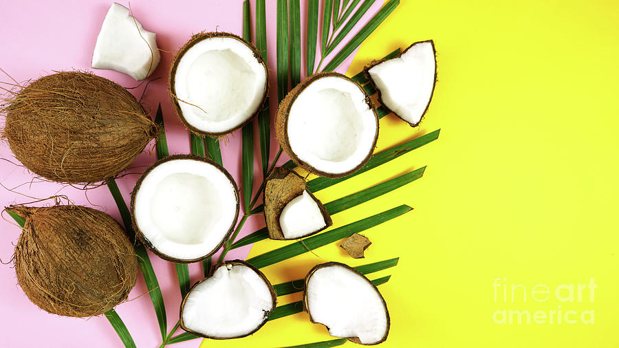 Coconut cut into pieces on modern colorful creative flat lay layout overhead. #2 Photograph by Milleflore Images