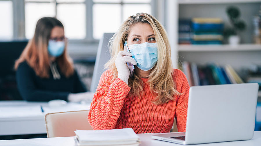 Colleagues in the office working while wearing medical face mask during COVID-19 #2 Photograph by Valentinrussanov