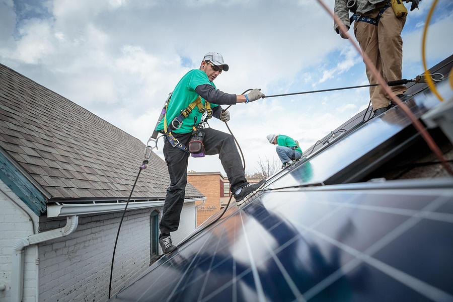 Construction crew installing solar panels on a house #2 Photograph by Heshphoto