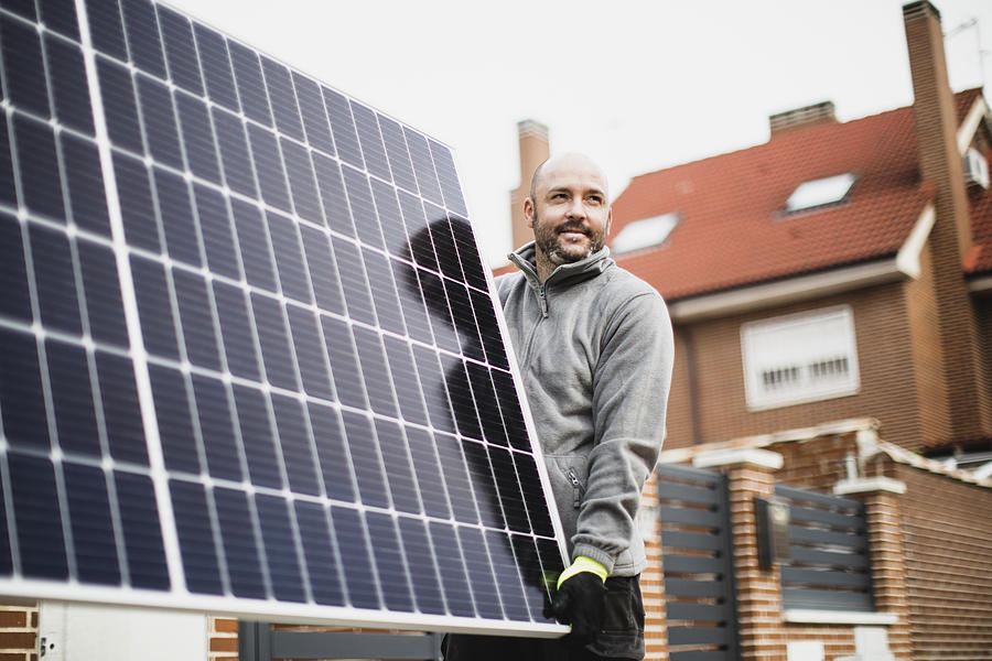 Construction Worker Installing Solar Panels #2 Photograph by Lourdes  Balduque