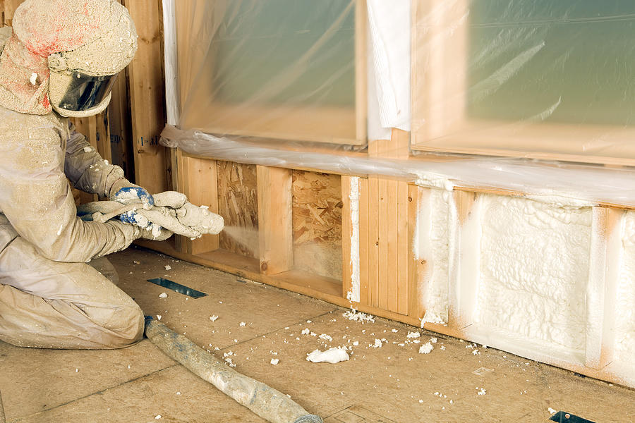 Construction Worker Spraying Expandable Foam Insulation between Wall Studs #2 Photograph by BanksPhotos