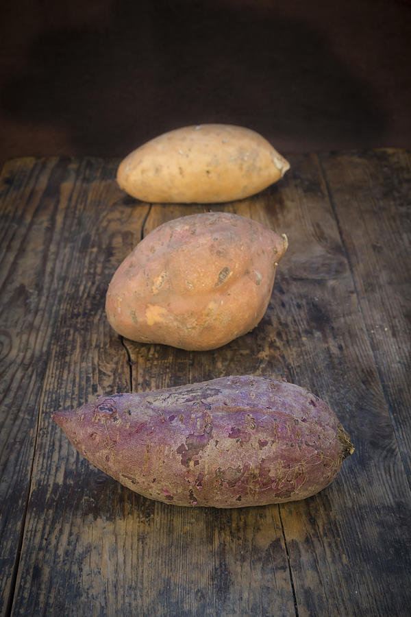 Different Sweet Potatoes On Dark Wood #2 Photograph by Larissa Veronesi