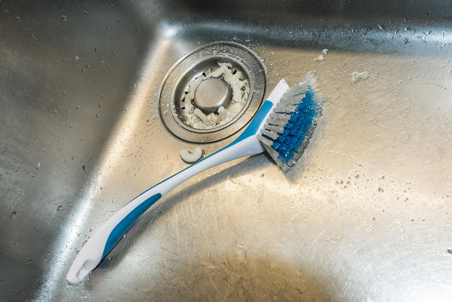 Dirty dishwashing brush in the sink #2 Photograph by EThamPhoto