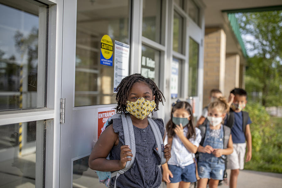 Diverse group of elementary school kids go back to school wearing masks #2 Photograph by FatCamera