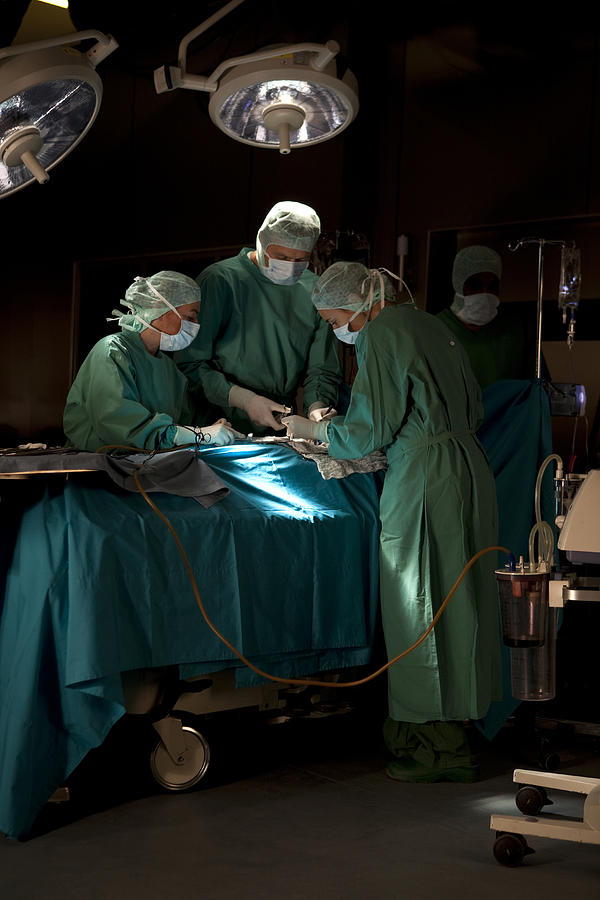 Doctors and nurses operating on a patient in a operating room #2 Photograph by Antenna