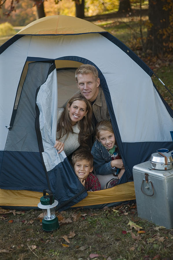 Family sitting in tent #2 Photograph by Comstock Images