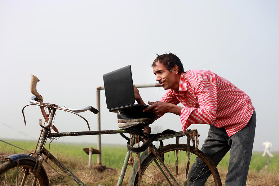 Farmer using laptop in the field #2 Photograph by Pixelfusion3d