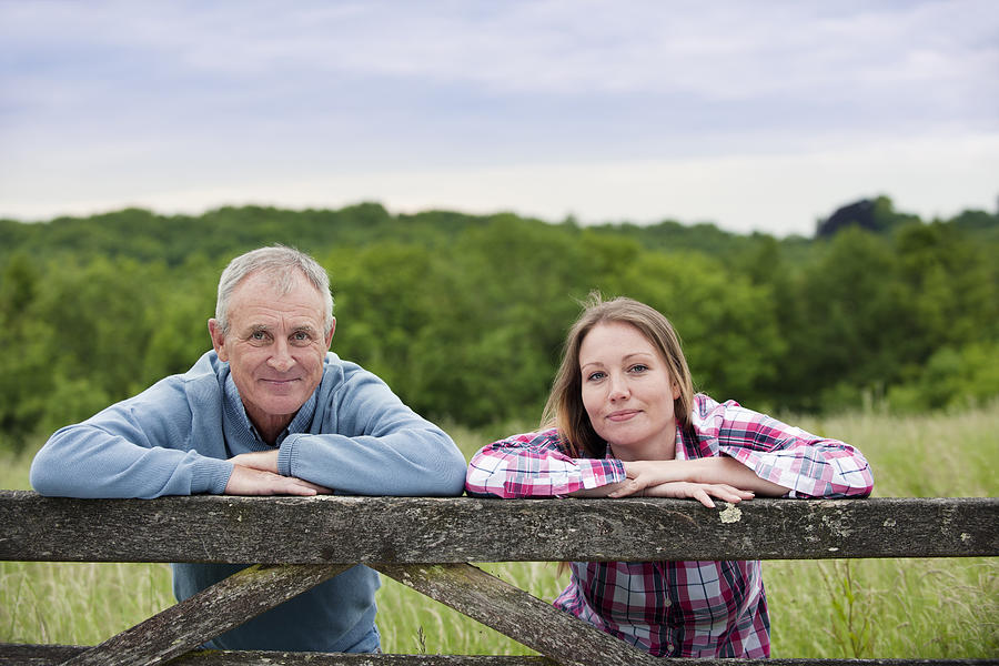 Father and daughter on wooden fence #2 Photograph by Colin Hawkins